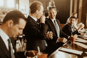 men in suits drinking cocktails