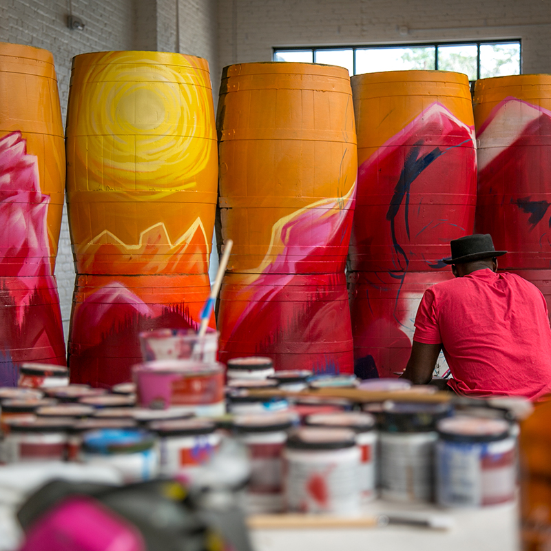 artist painting barrels