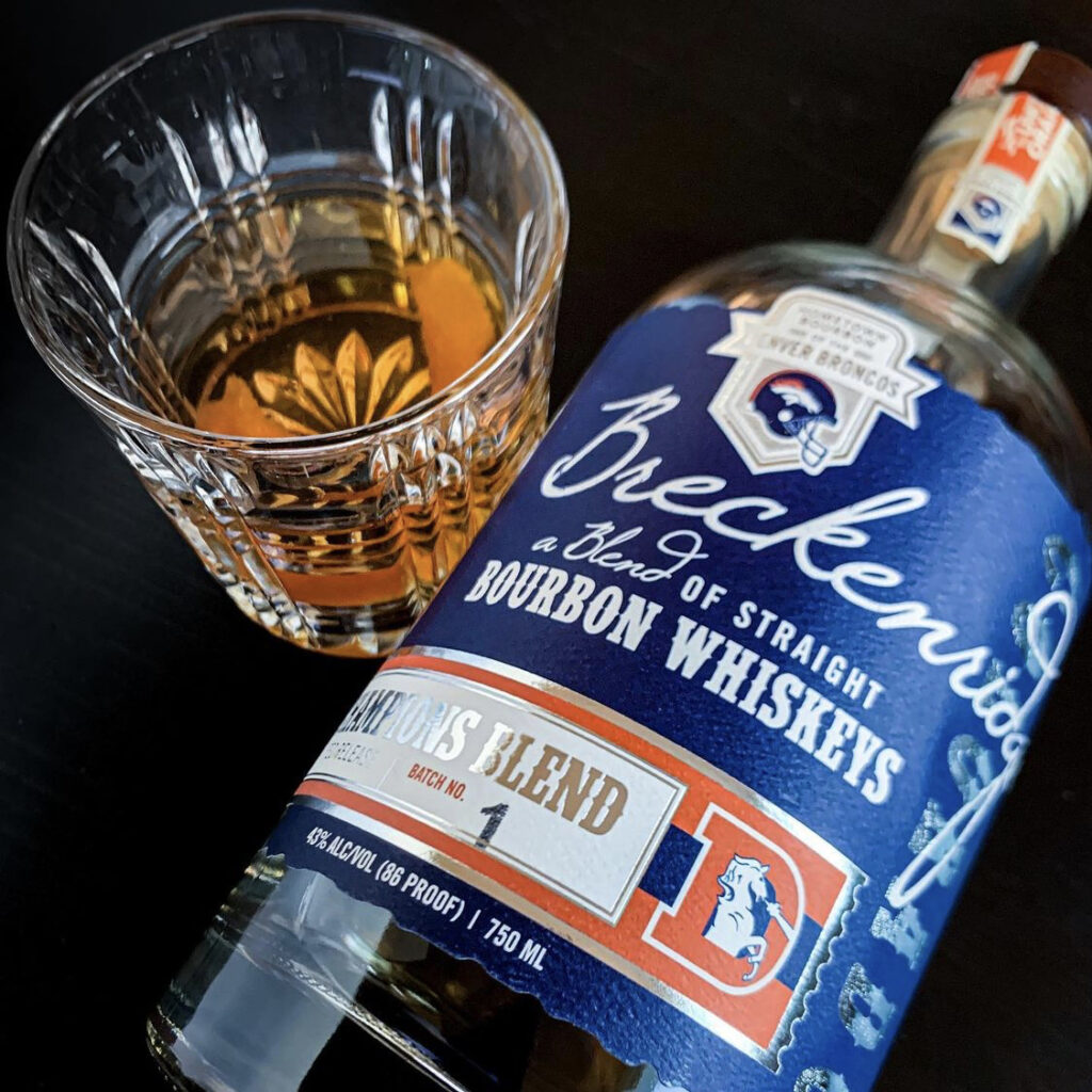 @dramgoodbourbon image with broncos breckenridge bourbon whiskey blue edition and rocks glass full of whiskey