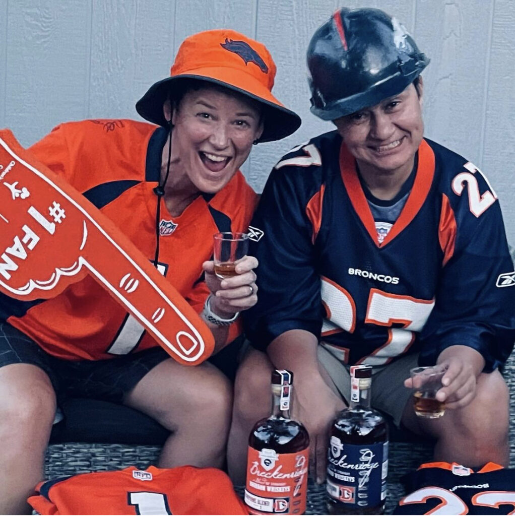 @lilt20_1974 Denver Broncos fans in Broncos gear with bottles of Denver Broncos Blends Breckenridge Bourbon Whiskey